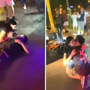 A prankster lay motionless beside his toppled bike while his girlfriend rushed over in tears