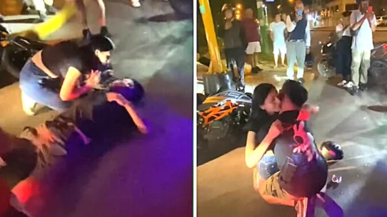 A prankster lay motionless beside his toppled bike while his girlfriend rushed over in tears