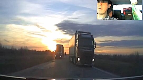 Dashcam footage shows a driver in Kazakhstan threading between two oncoming lorries