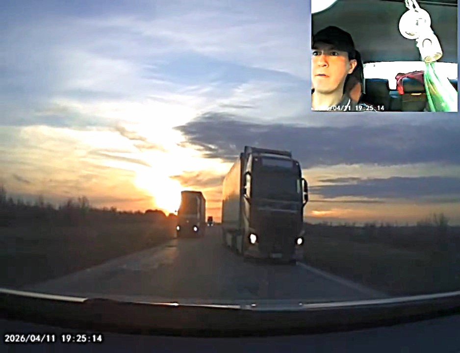 Dashcam footage shows a driver in Kazakhstan threading between two oncoming lorries