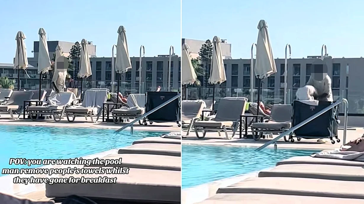 A hotel worker in Rhodes clears towels off reserved sunbeds