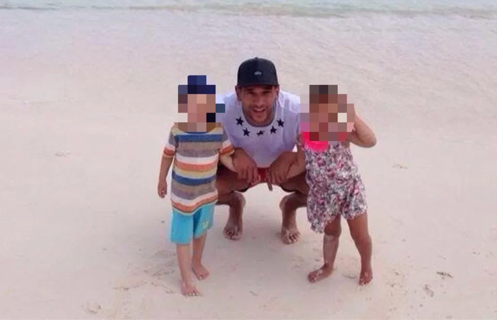 Steven Caulker posing with two young children on a beach