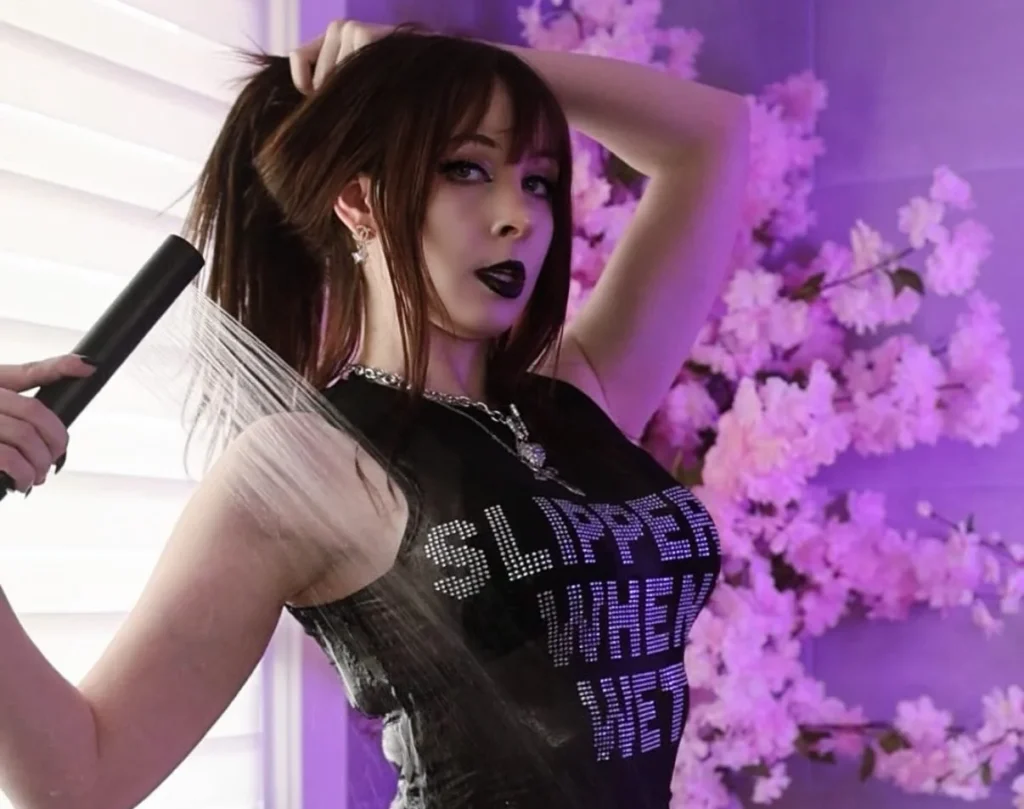 Woman in black crop top against purple floral background